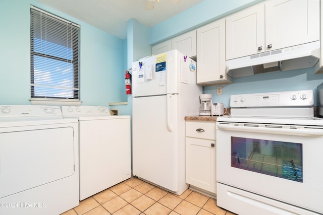 kitchen featuring white appliances, a textured ceiling, light tile patterned floors, separate washer and dryer, and white cabinetry