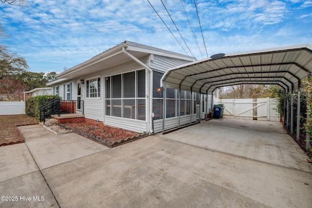 exterior space with a carport and a sunroom