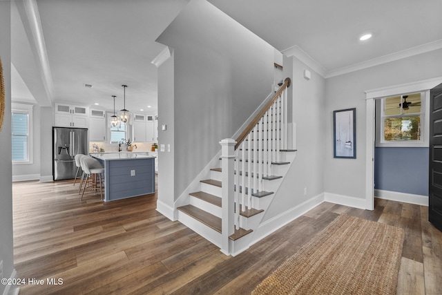 stairway with wood-type flooring and plenty of natural light