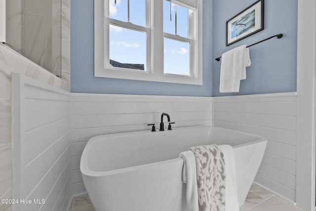 bathroom featuring a tub to relax in