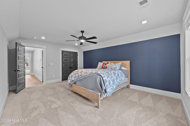 bedroom featuring ceiling fan, light carpet, and lofted ceiling