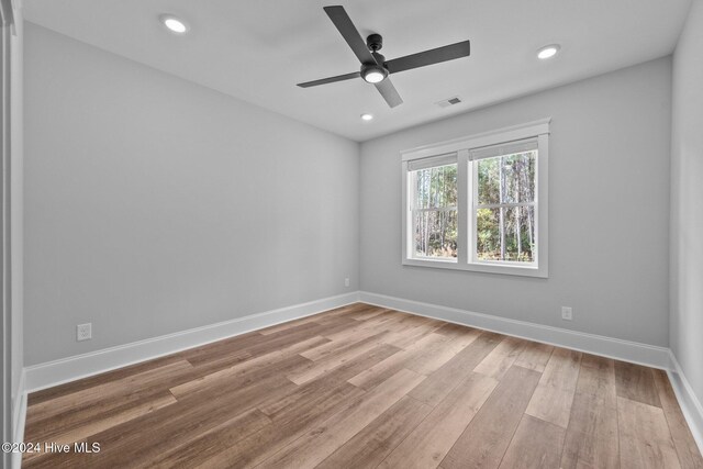 empty room featuring ceiling fan and light hardwood / wood-style floors