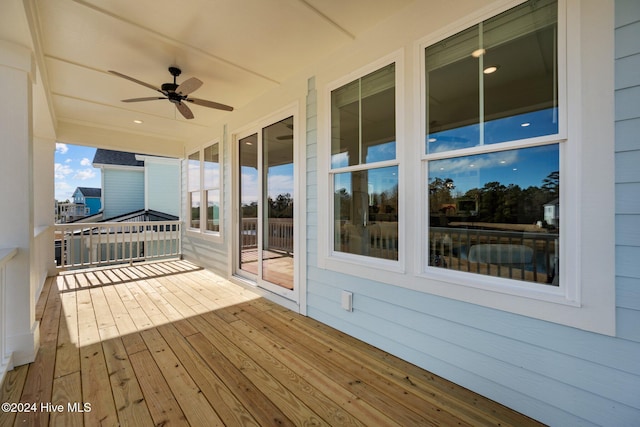 wooden terrace featuring ceiling fan