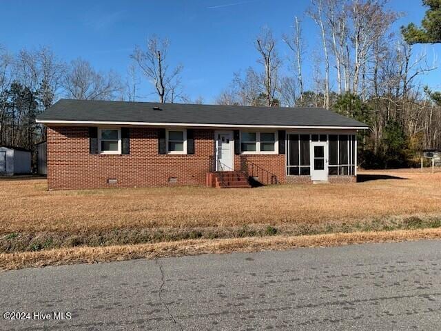 ranch-style home with a front lawn