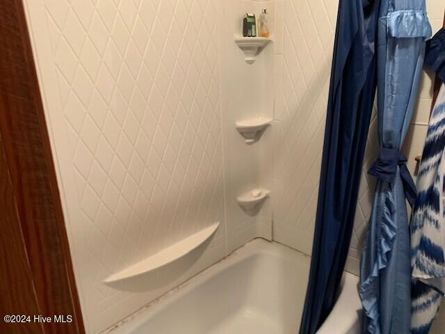 bathroom featuring shower / bathtub combination with curtain