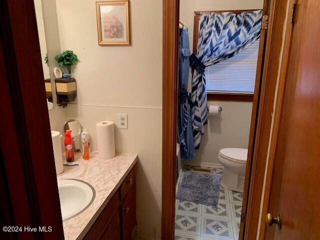 bathroom featuring vanity and toilet