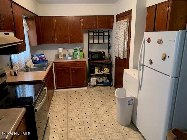 kitchen featuring white fridge, extractor fan, stainless steel range with electric cooktop, and sink