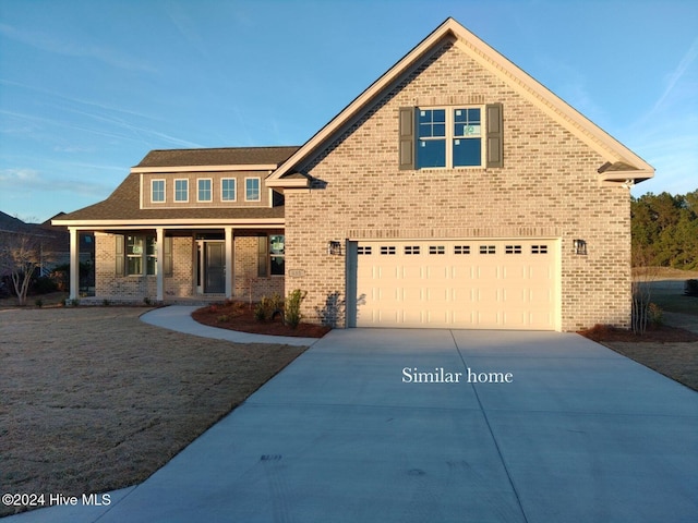 view of front of home featuring covered porch and a garage