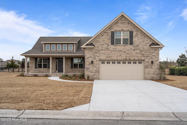 view of front of home featuring brick siding, driveway, and a garage