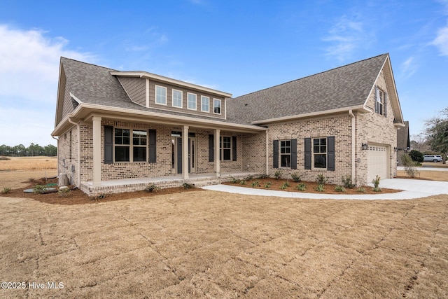 view of front facade featuring brick siding, a porch, concrete driveway, and an attached garage