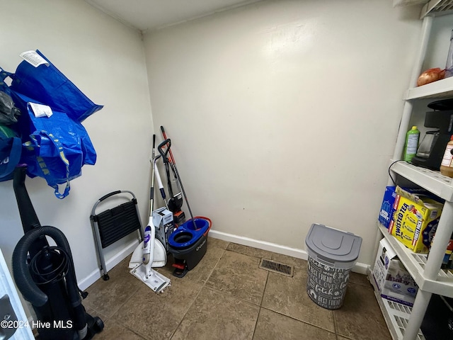 miscellaneous room with dark tile patterned flooring