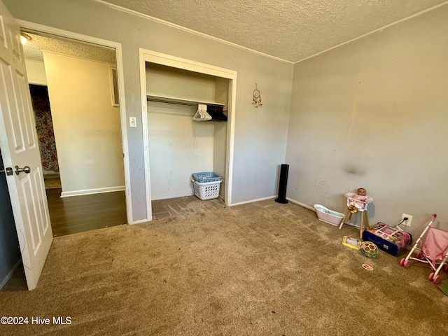 unfurnished bedroom with a closet, carpet floors, and a textured ceiling