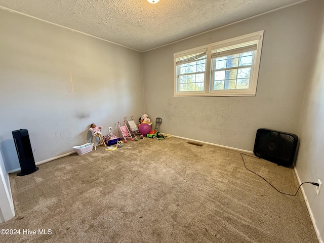 game room with carpet floors and a textured ceiling