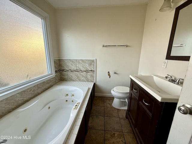 bathroom with tile patterned floors, vanity, a relaxing tiled tub, and toilet