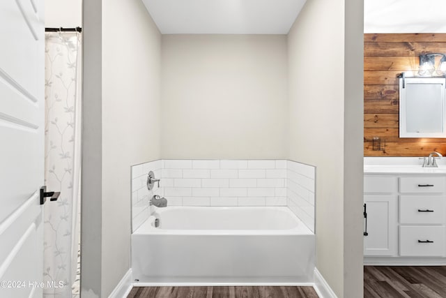 bathroom featuring a bathing tub, vanity, and hardwood / wood-style flooring