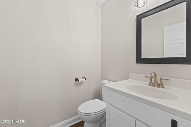 bathroom with wood walls, vanity, and wood-type flooring