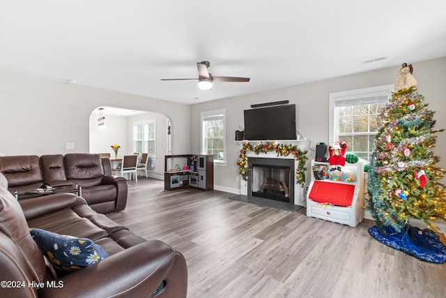 living room featuring hardwood / wood-style floors and ceiling fan