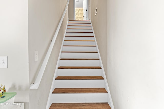 stairway with hardwood / wood-style flooring