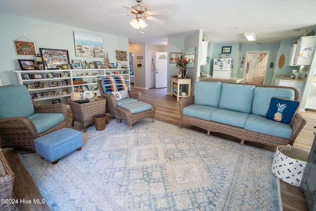 living room with ceiling fan and hardwood / wood-style floors