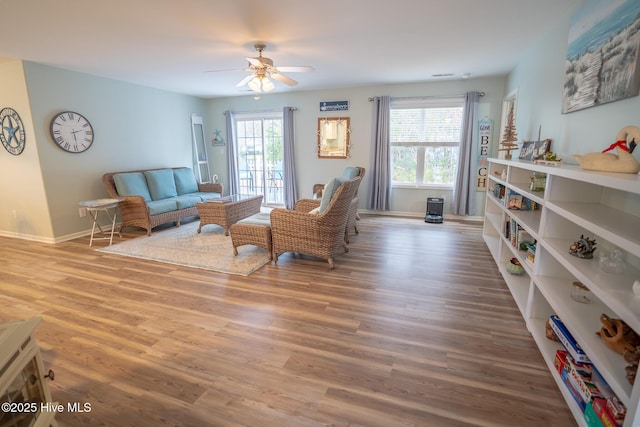 living room with ceiling fan, hardwood / wood-style floors, and a healthy amount of sunlight