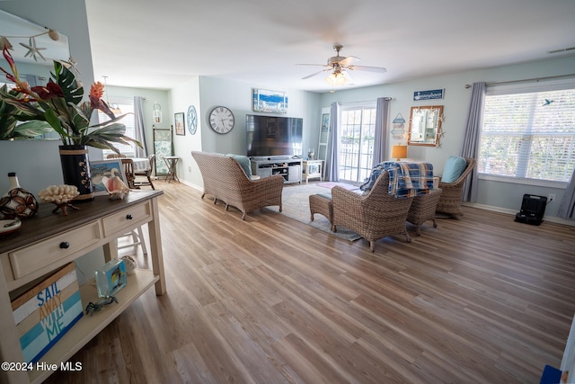 living room with ceiling fan and hardwood / wood-style floors