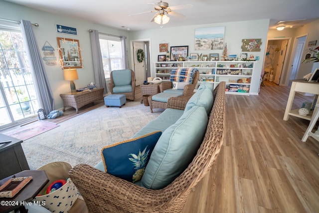 living room featuring wood-type flooring and ceiling fan