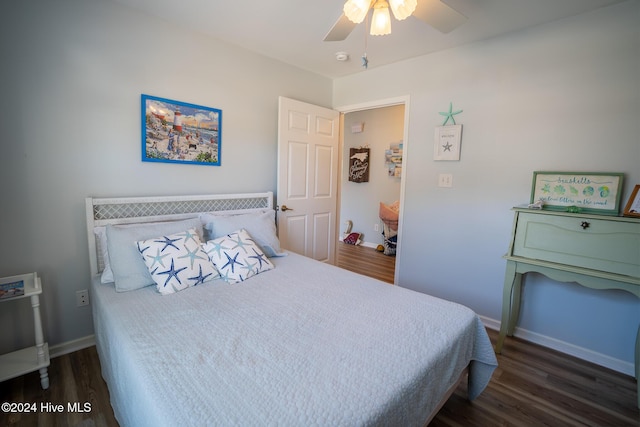 bedroom with ceiling fan and dark hardwood / wood-style flooring