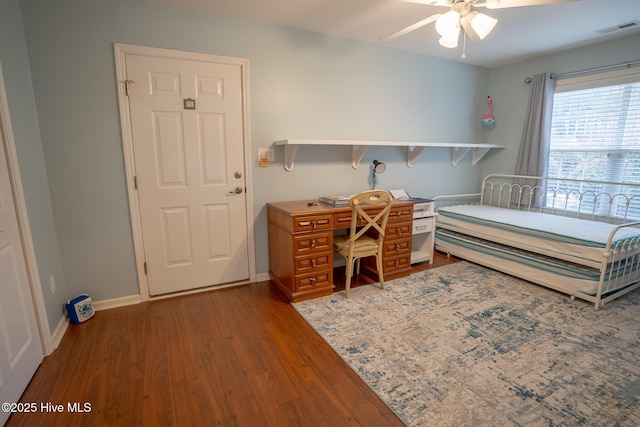 bedroom featuring ceiling fan and dark wood-type flooring