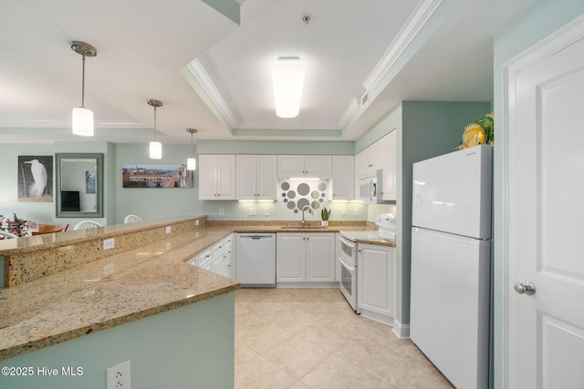 kitchen featuring white appliances, pendant lighting, white cabinets, and a peninsula