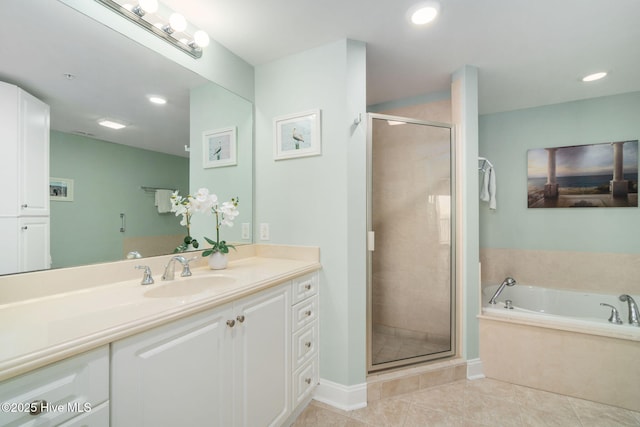 bathroom with a shower stall, vanity, a bath, and tile patterned floors