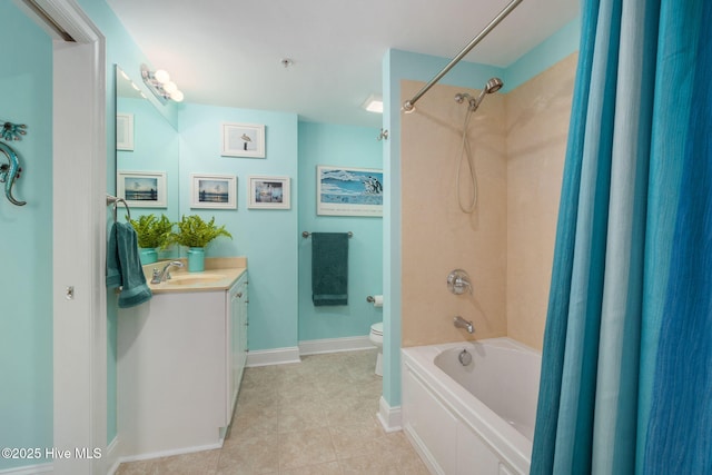 bathroom featuring vanity, baseboards, shower / washtub combination, tile patterned flooring, and toilet