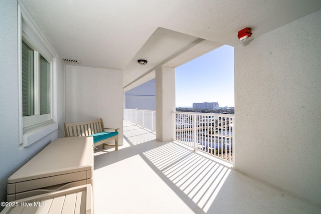 balcony with a sunroom and visible vents