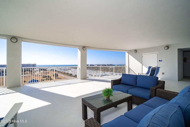 view of patio featuring a water view and an outdoor living space