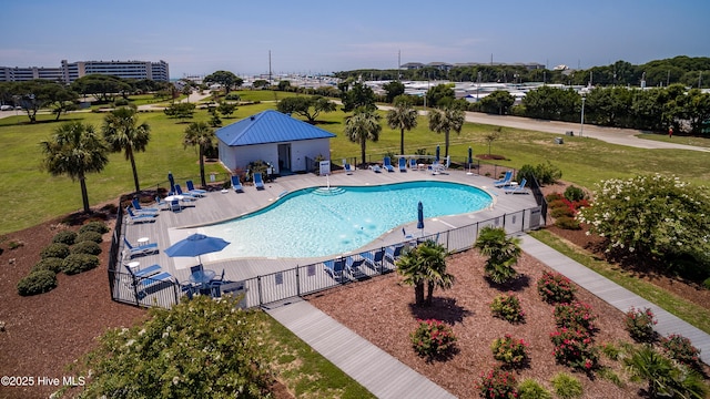 community pool with fence, a patio, and a yard