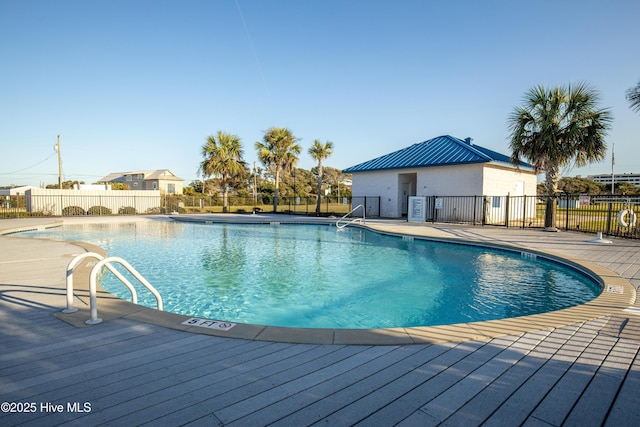 pool featuring fence and a patio area