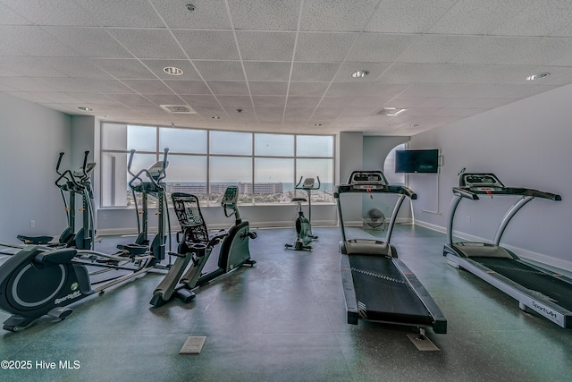 workout area featuring baseboards, visible vents, and a drop ceiling