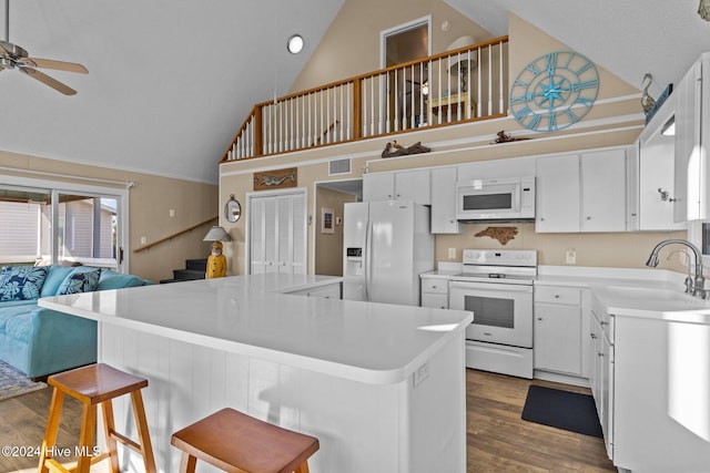 kitchen with white cabinets, white appliances, dark hardwood / wood-style floors, and high vaulted ceiling