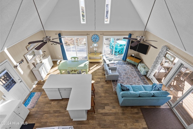 living room featuring high vaulted ceiling, ceiling fan, and dark wood-type flooring