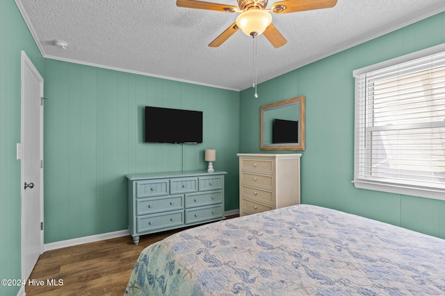 bedroom featuring a textured ceiling, ceiling fan, ornamental molding, and dark wood-type flooring