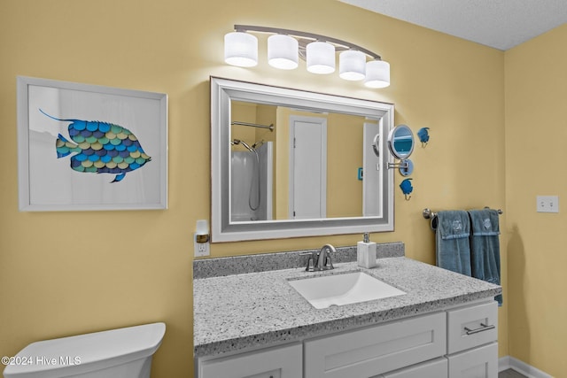 bathroom with vanity, a shower with shower curtain, a textured ceiling, and toilet