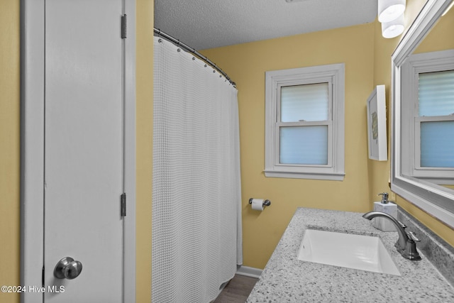 bathroom featuring vanity and a textured ceiling