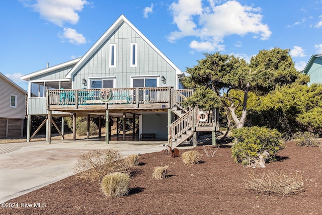 rear view of property with a carport and a deck