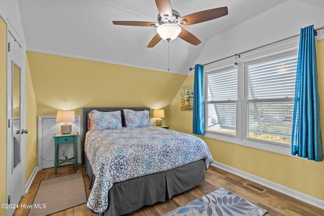 bedroom with ceiling fan, ornamental molding, lofted ceiling, and hardwood / wood-style flooring