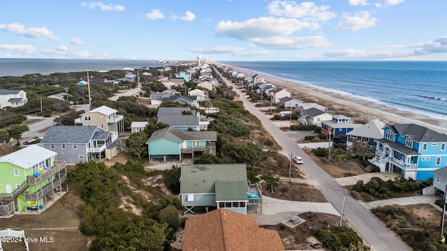 bird's eye view with a water view and a beach view