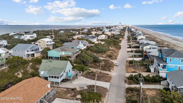 drone / aerial view featuring a water view and a view of the beach