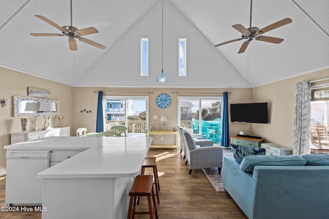 living room with dark hardwood / wood-style floors, high vaulted ceiling, and ceiling fan