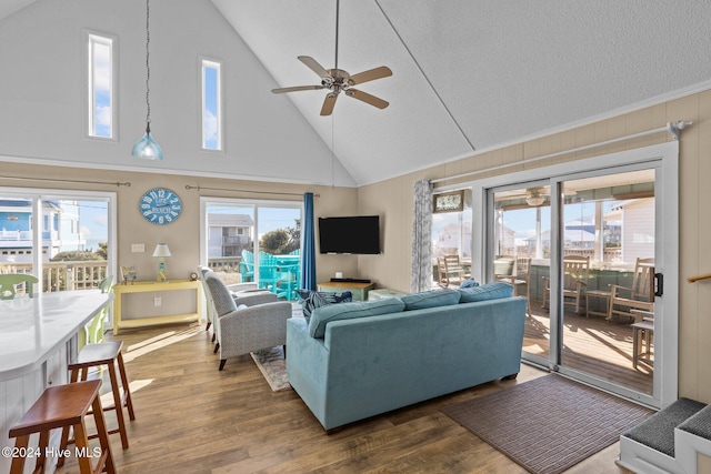 living room featuring dark hardwood / wood-style flooring, high vaulted ceiling, and ceiling fan