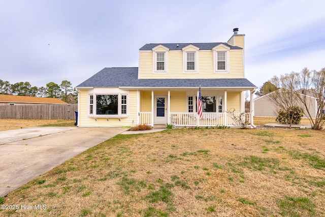 view of front of property with a front yard, fence, covered porch, a shingled roof, and a chimney