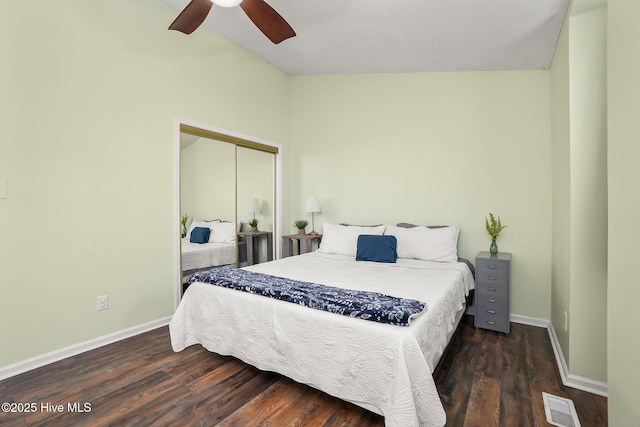 bedroom featuring a closet, visible vents, baseboards, and wood finished floors