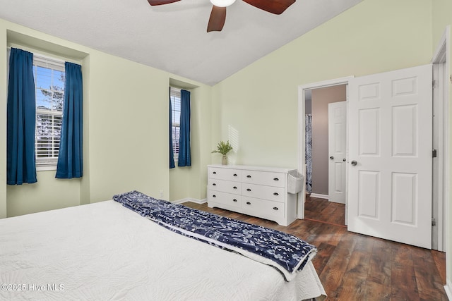 bedroom featuring baseboards, a ceiling fan, lofted ceiling, and wood finished floors